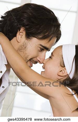Side profile of a father looking at his daughter View Large Photo Image Stock Photo - Side profile of a father looking at his daughter. Fotosearch