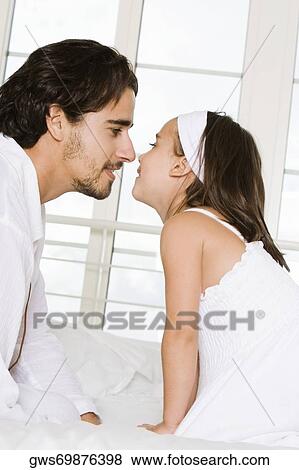 Side profile of a father looking at his daughter View Large Photo Image Stock Photo - Side profile of a father looking at his daughter. Fotosearch