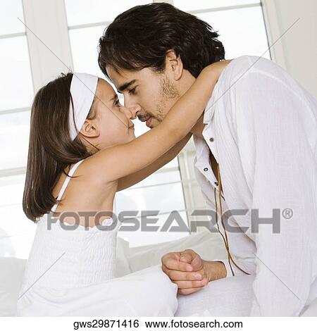 Side profile of a father looking at his daughter View Large Photo Image Stock Photograph - Side profile of a father looking at his daughter. Fotosearch