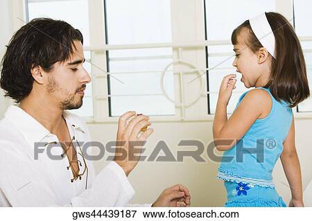 Stock Photo - Side profile of a father with his daughter. Fotosearch