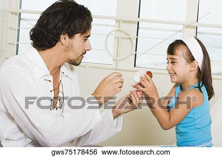 Side profile of a father with his daughter View Large Photo Image Stock Photograph - Side profile of a father with his daughter. Fotosearch