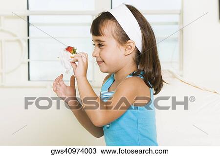Side profile of a girl holding a sandwich View Large Photo Image Stock Image - Side profile of a girl holding a sandwich. Fotosearch