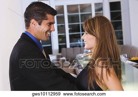 Side profile of a mid adult couple looking at each other View Large Photo Image Stock Photo - Side profile of a mid adult couple looking at each other. Fotosearch