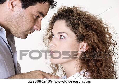 Side profile of a mid adult man and a young woman arguing View Large Photo Image Stock Photo - Side profile of a mid adult man and a young woman arguing. Fotosearch