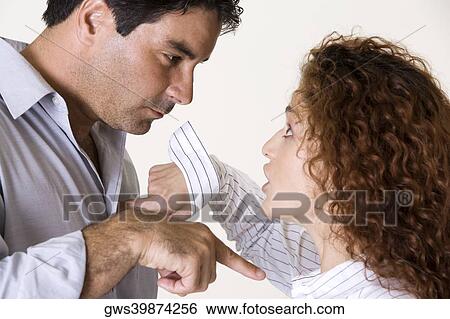 Side profile of a mid adult man and a young woman arguing View Large Photo Image Stock Photograph - Side profile of a mid adult man and a young woman arguing. Fotosearch