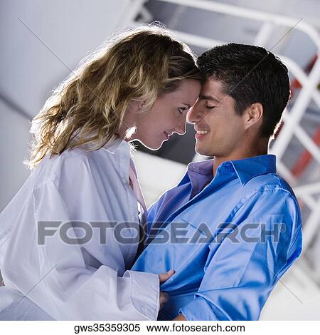 Side profile of a mid adult man and a young woman looking at each other View Large Photo Image Stock Photography - Side profile of a mid adult man and a young woman looking at each other. Fotosearch