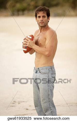 Side profile of a mid adult man holding a rugby ball View Large Photo Image Stock Photography - Side profile of a mid adult man holding a rugby ball. Fotosearch