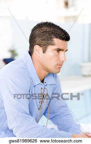 Side profile of a mid adult man looking serious View Large Photo Image Stock Photograph - Side profile of a mid adult man looking serious. Fotosearch