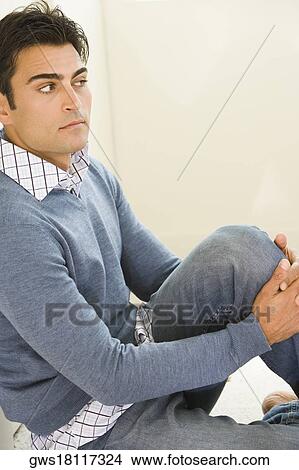Side profile of a mid adult man sitting on the floor View Large Photo Image Picture - Side profile of a mid adult man sitting on the floor. Fotosearch