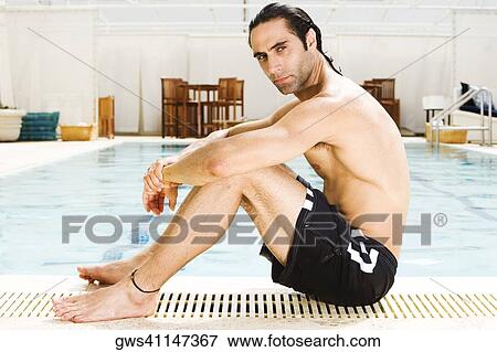 Side profile of a mid adult man sitting at the edge of a swimming pool View Large Photo Image Stock Photo - Side profile of a mid adult man sitting at the edge of a swimming pool. Fotosearch