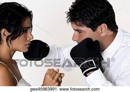 Side profile of a mid adult man punching a young woman View Large Photo Image Stock Image - Side profile of a mid adult man punching a young woman. Fotosearch
