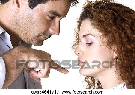 Side profile of a mid adult man pointing to a young woman View Large Photo Image Stock Photo - Side profile of a mid adult man pointing to a young woman. Fotosearch