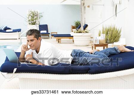 Side profile of a mid adult man using a laptop View Large Photo Image Stock Image - Side profile of a mid adult man using a laptop. Fotosearch