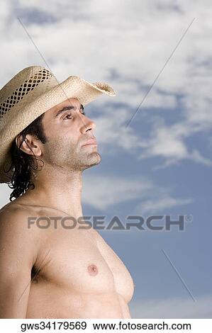 Side profile of a mid adult man wearing a hat View Large Photo Image Stock Photo - Side profile of a mid adult man wearing a hat. Fotosearch