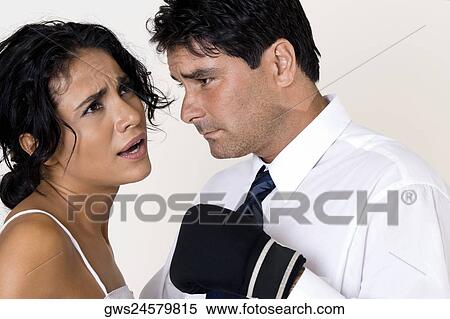 Side profile of a mid adult man wearing boxing gloves standing in front of a young woman View Large Photo Image Stock Photography - Side profile of a mid adult man wearing boxing gloves standing in front of a young woman. Fotosearch