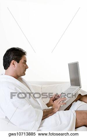 Side profile of a mid adult man working on a laptop View Large Photo Image Stock Photography - Side profile of a mid adult man working on a laptop. Fotosearch