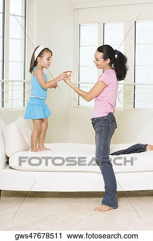 Side profile of a mother giving her daughter a pastry View Large Photo Image Stock Image - Side profile of a mother giving her daughter a pastry. Fotosearch