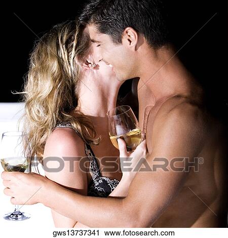 Side profile of a young couple embracing each other View Large Photo Image Stock Image - Side profile of a young couple embracing each other. Fotosearch