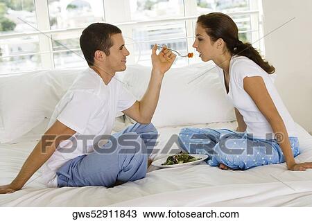 Side profile of a young man feeding a young woman cherries View Large Photo Image Stock Image - Side profile of a young man feeding a young woman cherries. Fotosearch