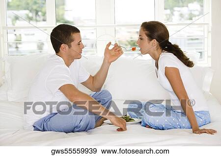 Side profile of a young man feeding a young woman cherries View Large Photo Image Stock Photo - Side profile of a young man feeding a young woman cherries. Fotosearch