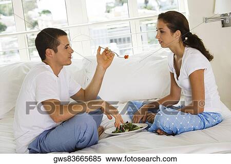 Side profile of a young man feeding a young woman cherries View Large Photo Image Stock Photography - Side profile of a young man feeding a young woman cherries. Fotosearch