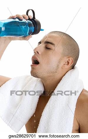 Side profile of a young man pouring water on his face View Large Photo Image Stock Image - Side profile of a young man pouring water on his face. Fotosearch