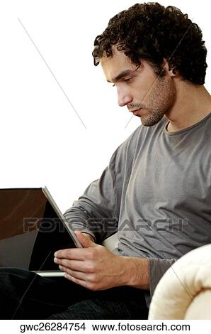 Side profile of a young man using a laptop View Large Photo Image Picture - Side profile of a young man using a laptop. Fotosearch