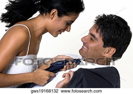 Side profile of a young woman and a mid adult man smiling View Large Photo Image Stock Image - Side profile of a young woman and a mid adult man smiling. Fotosearch