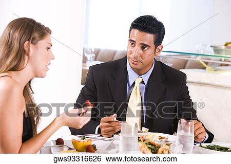 Side profile of a young woman and a mid adult man eating in a restaurant View Large Photo Image Stock Photograph - Side profile of a young woman and a mid adult man eating in a restaurant. Fotosearch