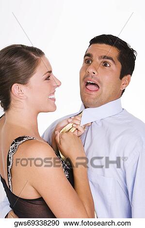 Side profile of a young woman choking a mid adult man with his tie View Large Photo Image Stock Image - Side profile of a young woman choking a mid adult man with his tie. Fotosearch