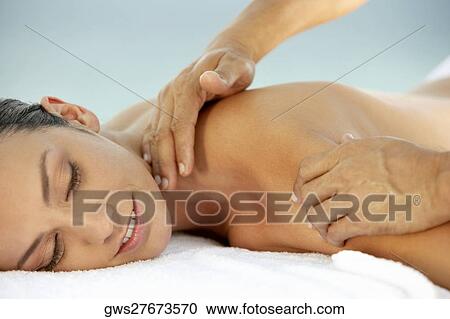 Side profile of a young woman getting a back massage View Large Photo Image Stock Image - Side profile of a young woman getting a back massage. Fotosearch