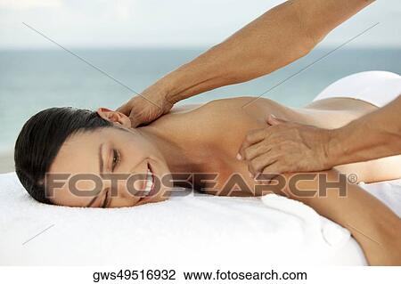 Side profile of a young woman getting a back massage View Large Photo Image Stock Image - Side profile of a young woman getting a back massage. Fotosearch