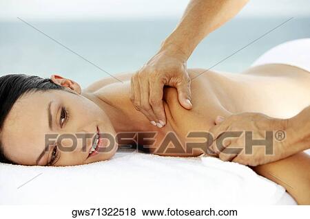 Side profile of a young woman getting a back massage View Large Photo Image Stock Photo - Side profile of a young woman getting a back massage. Fotosearch