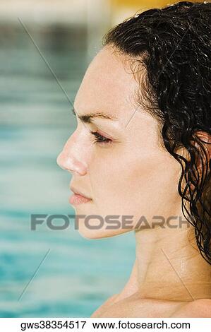 Side profile of a young woman in a swimming pool View Large Photo Image Stock Photo - Side profile of a young woman in a swimming pool. Fotosearch
