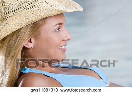 Side profile of a young woman smiling View Large Photo Image Stock Image - Side profile of a young woman smiling. Fotosearch