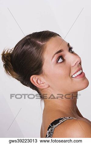 Side profile of a young woman smiling View Large Photo Image Stock Image - Side profile of a young woman smiling. Fotosearch