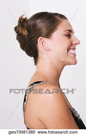 Side profile of a young woman smiling View Large Photo Image Stock Image - Side profile of a young woman smiling. Fotosearch