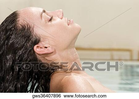 Side profile of a young woman with wet hair View Large Photo Image Stock Photograph - Side profile of a young woman with wet hair. Fotosearch