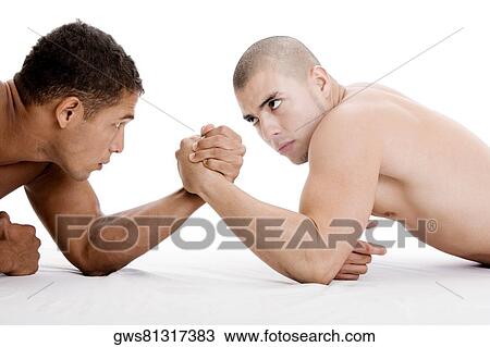 Side profile of two young men arm wrestling View Large Photo Image Stock Image - Side profile of two young men arm wrestling. Fotosearch
