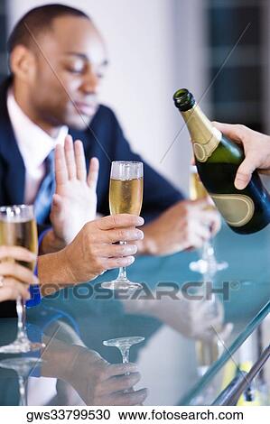Three people holding champagne flutes at a bar counter View Large Photo Image Stock Image - Three people holding champagne flutes at a bar counter. Fotosearch