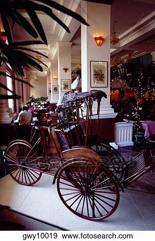Stock Photo - Trishaw in the lobby restaurant, Majestic Hotel, Ho Chi Minh City (formerly Saigon) Vietnam. Fotosearch