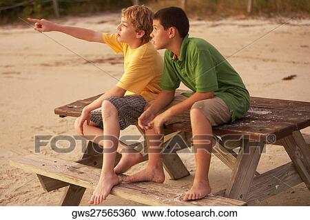 Two boys sitting on a picnic table View Large Photo Image Stock Image - Two boys sitting on a picnic table. Fotosearch