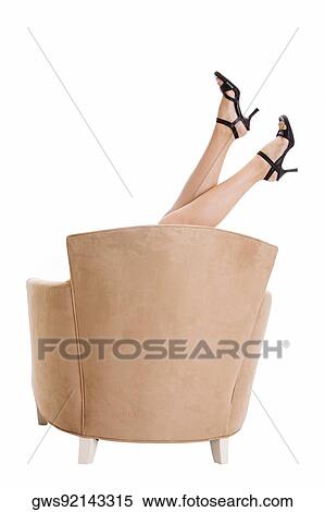 Woman's leg sticking up above an armchair View Large Photo Image Stock Photography - Woman's leg sticking up above an armchair. Fotosearch