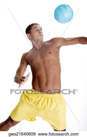 Young man hitting a ball View Large Photo Image Stock Photo - Young man hitting a ball. Fotosearch