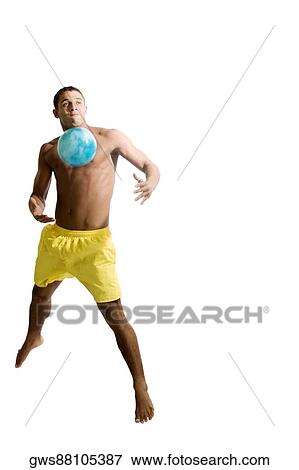 Young man playing with a ball View Large Photo Image Stock Photo - Young man playing with a ball. Fotosearch