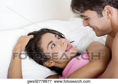 Young woman making a face at a young man View Large Photo Image Stock Photo - Young woman making a face at a young man. Fotosearch
