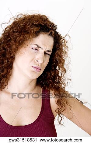 Young woman making a face with her eyes closed View Large Photo Image Stock Image - Young woman making a face with her eyes closed. Fotosearch