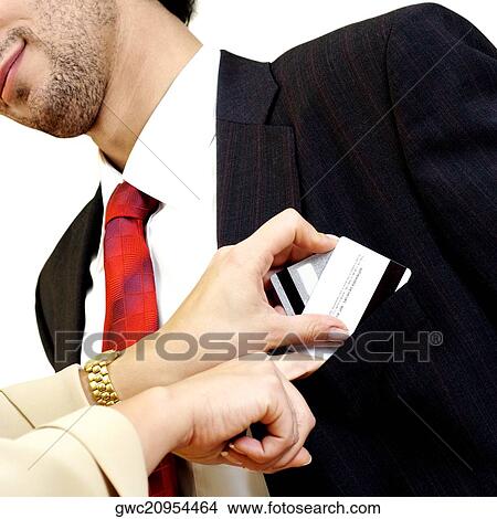Young woman putting credit cards into young man's pocket View Large Photo Image Picture - Young woman putting credit cards into young man's pocket. Fotosearch