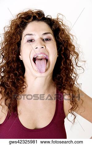 Young woman sticking out her tongue View Large Photo Image Stock Image - Young woman sticking out her tongue. Fotosearch