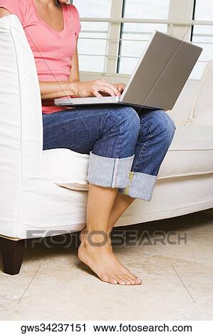 Young woman working on a laptop View Large Photo Image Stock Image - Young woman working on a laptop. Fotosearch